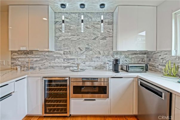 Interior, Kitchen, Marble Walls, Pendant Lights, Stainless Steel Appliances, Wood Texture Flooring