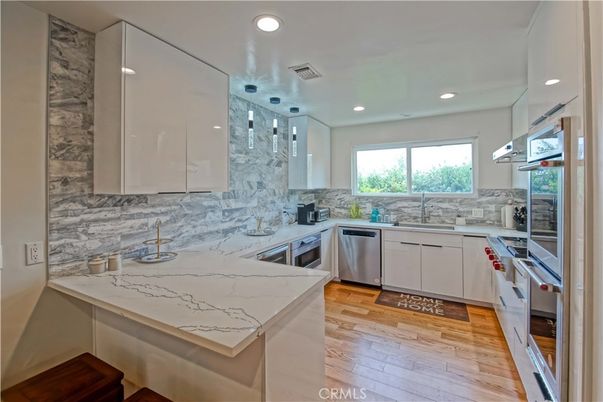Interior, Kitchen, Marble Walls, Pendant Lights, Recessed Lighting, Stainless Steel Appliances, Wood Texture Flooring