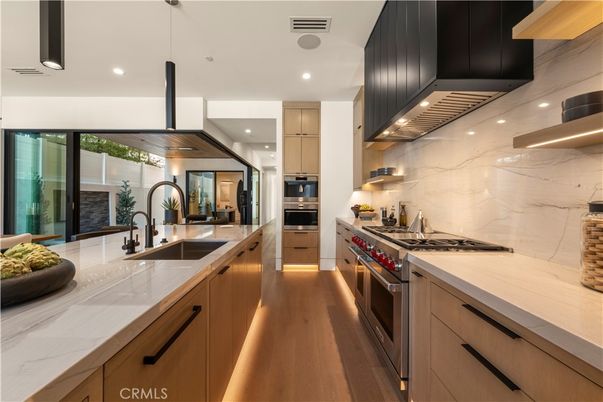 Interior, Kitchen, Marble Walls, Recessed Lighting, Stainless Steel Appliances, Wood Texture Flooring