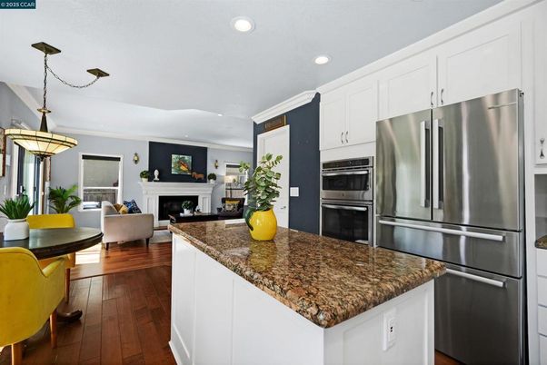 Fireplace, Interior, Kitchen, Living room, Pendant Lights, Recessed Lighting, Stainless Steel Appliances, Wood Texture Flooring