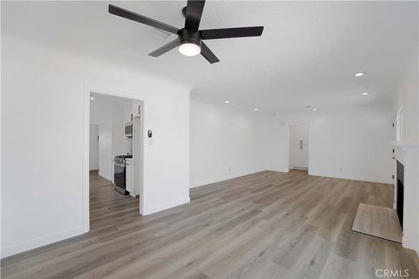 Empty room, Fireplace, Interior, Kitchen, Recessed Lighting, Wood Texture Flooring