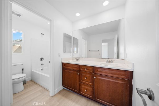 Bathroom, Dual Sink Vanities, Interior, Recessed Lighting, Wood Texture Flooring