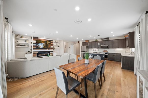 Dining room, Fireplace, Interior, Kitchen, Living room, Pendant Lights, Recessed Lighting, Stainless Steel Appliances, Wood Texture Flooring