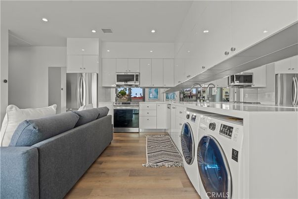 Interior, Kitchen, Living room, Recessed Lighting, Stainless Steel Appliances, Washer, Wood Texture Flooring
