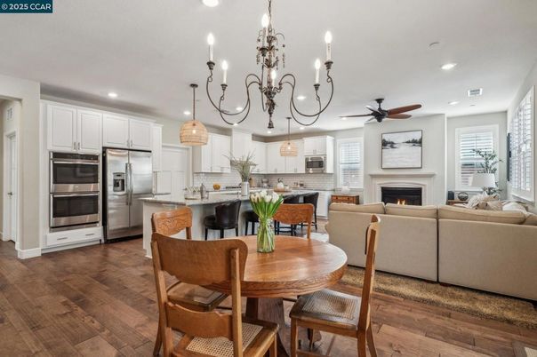 Chandelier, Dining room, Fireplace, Interior, Kitchen, Living room, Pendant Lights, Recessed Lighting, Stainless Steel Appliances, Wood Texture Flooring