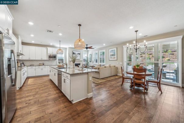 Chandelier, Dining room, Interior, Kitchen, Living room, Pendant Lights, Recessed Lighting, Stainless Steel Appliances, Wood Texture Flooring