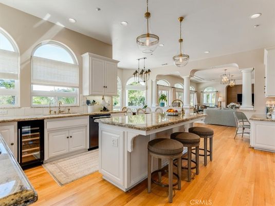 Chandelier, Dining room, Interior, Kitchen, Living room, Pendant Lights, Recessed Lighting, Stainless Steel Appliances, Wood Texture Flooring