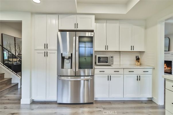Fireplace, Interior, Kitchen, Recessed Lighting, Stainless Steel Appliances, Wood Texture Flooring