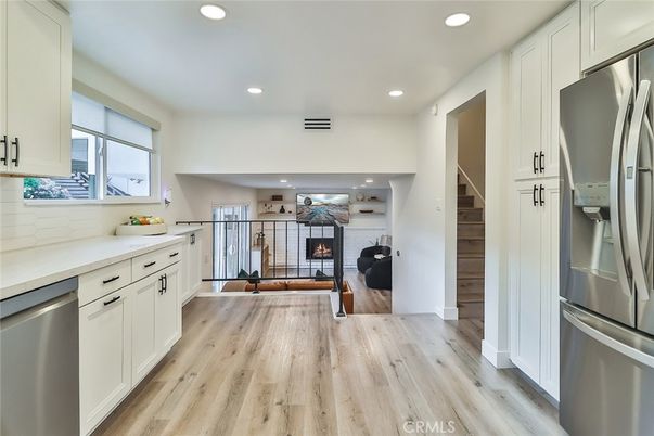 Fireplace, Interior, Kitchen, Living room, Recessed Lighting, Stainless Steel Appliances, Wood Texture Flooring