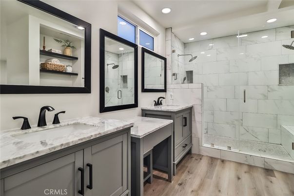 Bathroom, Dual Sink Vanities, Glass Shower, Interior, Marble Walls, Recessed Lighting, Wood Texture Flooring