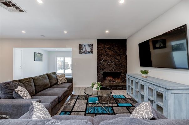 Fireplace, Interior, Living room, Recessed Lighting, Stone Walls, Wood Texture Flooring