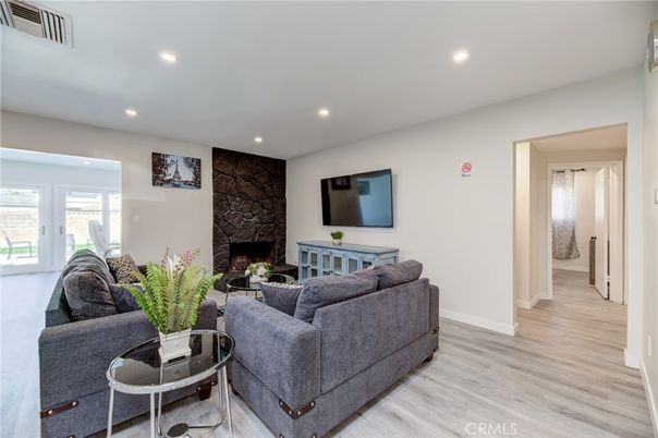 Fireplace, Interior, Living room, Recessed Lighting, Stone Walls, Wood Texture Flooring