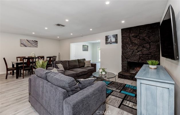 Dining room, Fireplace, Interior, Living room, Recessed Lighting, Stone Walls, Wood Texture Flooring