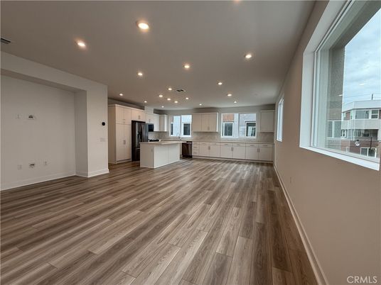 Empty room, Interior, Kitchen, Recessed Lighting, Stainless Steel Appliances, Wood Texture Flooring