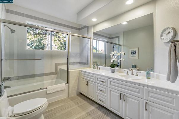 Bathroom, Dual Sink Vanities, Glass Shower, Interior, Recessed Lighting, Tile Countertops, Wood Texture Flooring