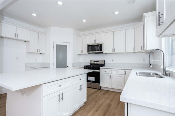 Interior, Kitchen, Recessed Lighting, Stainless Steel Appliances, Wood Texture Flooring