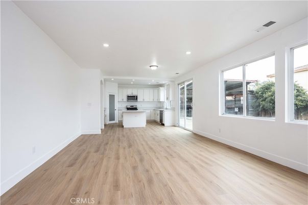 Empty room, Interior, Kitchen, Recessed Lighting, Stainless Steel Appliances, Wood Texture Flooring
