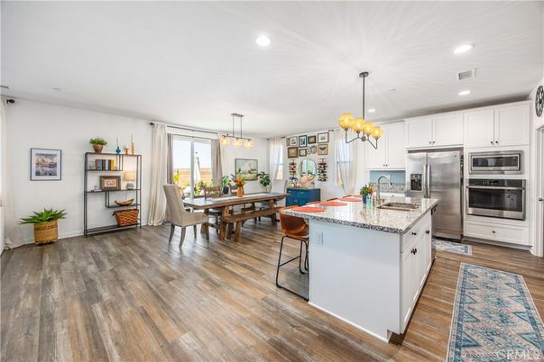 Chandelier, Dining room, Interior, Kitchen, Pendant Lights, Recessed Lighting, Stainless Steel Appliances, Wood Texture Flooring