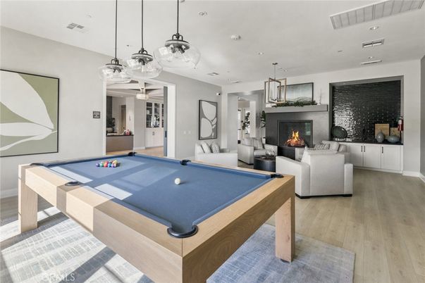 Billiard Table, Fireplace, Game Room, Interior, Living room, Pendant Lights, Recessed Lighting, Wood Texture Flooring