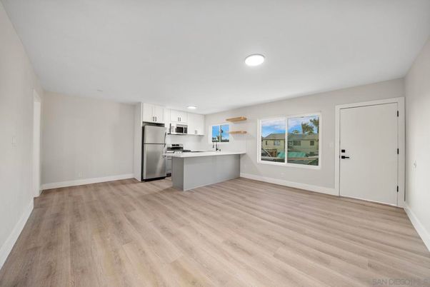 Empty room, Interior, Kitchen, Recessed Lighting, Stainless Steel Appliances, Wood Texture Flooring