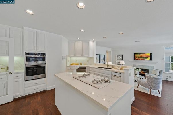 Fireplace, Interior, Kitchen, Living room, Recessed Lighting, Stainless Steel Appliances, Wood Texture Flooring