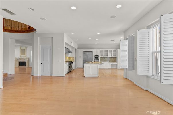 Empty room, Fireplace, Interior, Kitchen, Recessed Lighting, Wood Texture Flooring