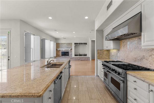 Fireplace, Interior, Kitchen, Recessed Lighting, Stainless Steel Appliances, Wood Texture Flooring
