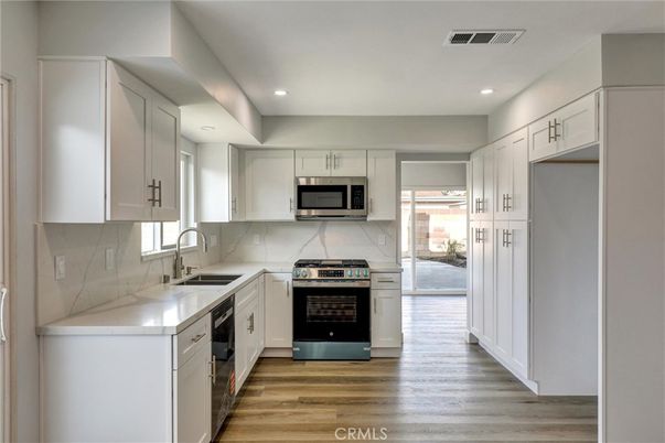 Interior, Kitchen, Marble Walls, Recessed Lighting, Stainless Steel Appliances, Wood Texture Flooring