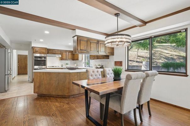 Chandelier, Dining room, Interior, Kitchen, Pendant Lights, Recessed Lighting, Stainless Steel Appliances, Wooden Beams, Wood Texture Flooring