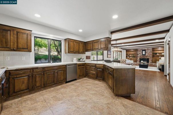 Fireplace, Interior, Kitchen, Living room, Pendant Lights, Recessed Lighting, Stainless Steel Appliances, Stone Walls, Wood Texture Flooring