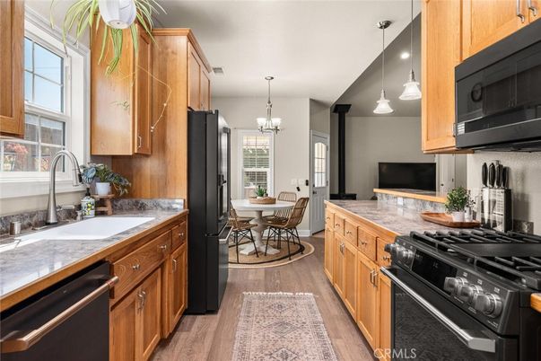 Chandelier, Dining room, Interior, Kitchen, Pendant Lights, Recessed Lighting, Stainless Steel Appliances, Wood Texture Flooring
