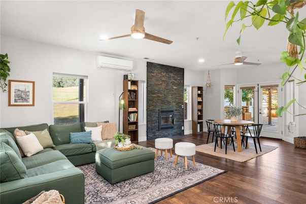 Dining room, Fireplace, Interior, Living room, Recessed Lighting, Stone Walls, Wood Texture Flooring