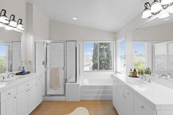 Bathroom, Dual Sink Vanities, Glass Shower, Interior, Recessed Lighting, Tile Countertops, Wood Texture Flooring