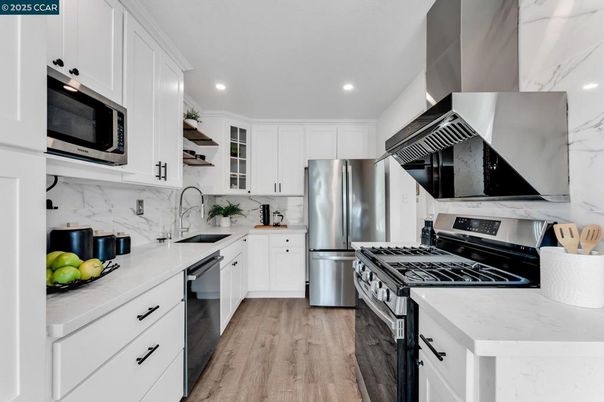 Interior, Kitchen, Marble Walls, Recessed Lighting, Stainless Steel Appliances, Wood Texture Flooring