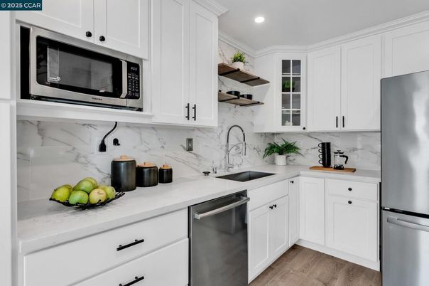 Interior, Kitchen, Marble Walls, Recessed Lighting, Stainless Steel Appliances, Wood Texture Flooring