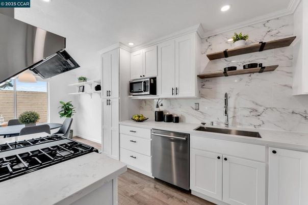Interior, Kitchen, Marble Walls, Recessed Lighting, Stainless Steel Appliances, Wood Texture Flooring