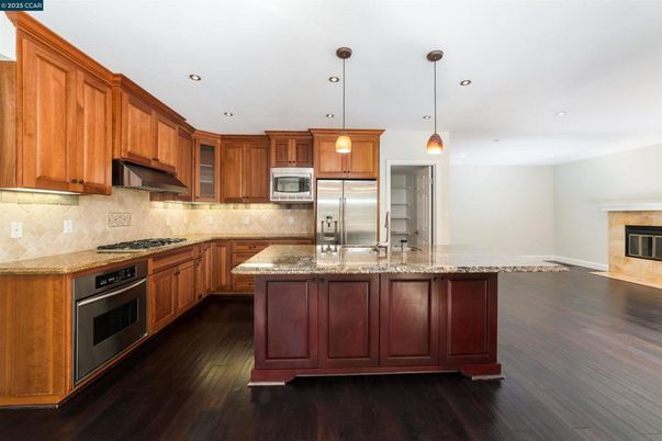 Fireplace, Interior, Kitchen, Pendant Lights, Recessed Lighting, Stainless Steel Appliances, Wood Texture Flooring