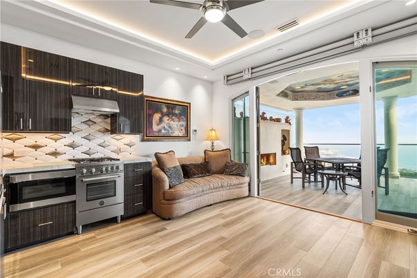 Dining room, Fireplace, Interior, Kitchen, Recessed Lighting, Stainless Steel Appliances, Water, Wood Texture Flooring
