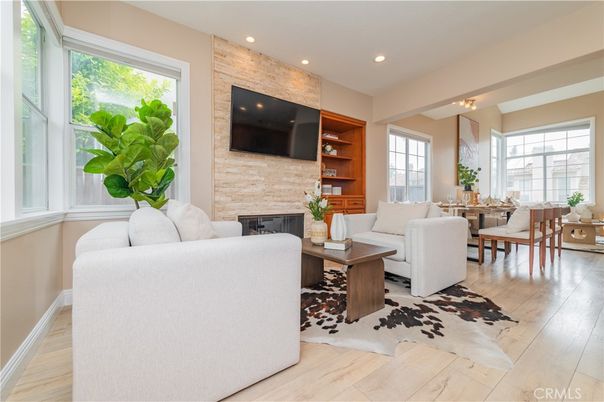 Dining room, Fireplace, Interior, Living room, Recessed Lighting, Stone Walls, Wood Texture Flooring