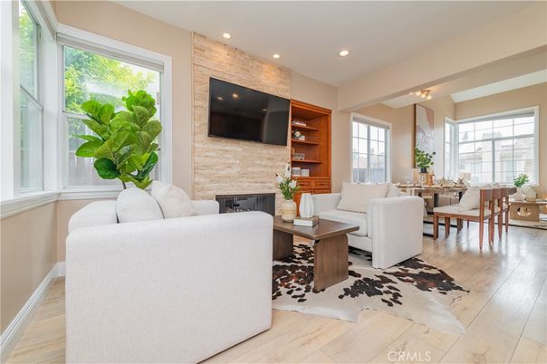 Dining room, Fireplace, Interior, Living room, Recessed Lighting, Stone Walls, Wood Texture Flooring