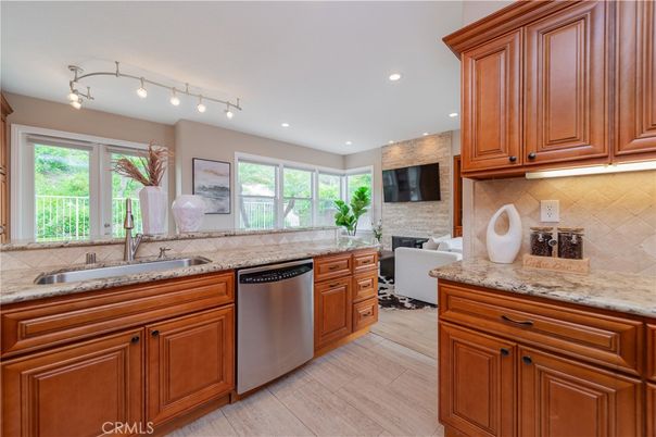Fireplace, Interior, Kitchen, Recessed Lighting, Stainless Steel Appliances, Stone Walls, Wood Texture Flooring