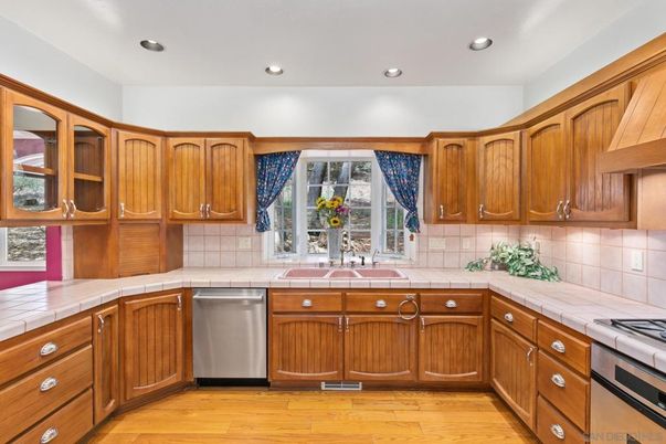 Interior, Kitchen, Recessed Lighting, Stainless Steel Appliances, Tile Countertops, Wood Texture Flooring