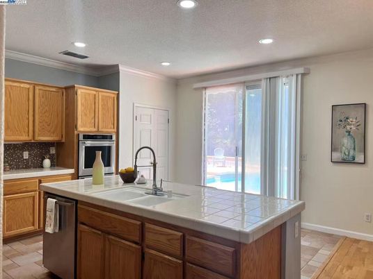 Interior, Kitchen, Recessed Lighting, Stainless Steel Appliances, Tile Countertops, Wood Texture Flooring