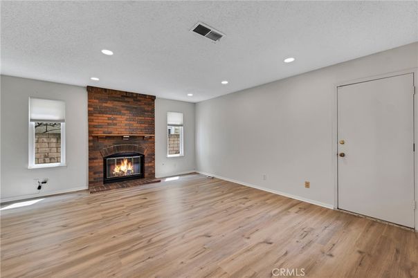 Empty room, Fireplace, Interior, Recessed Lighting, Stone Walls, Wood Texture Flooring