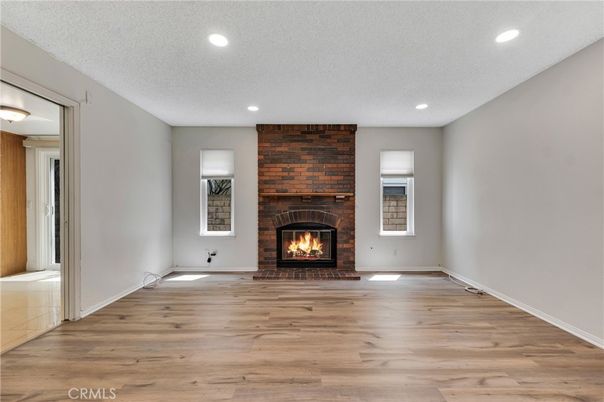 Empty room, Fireplace, Interior, Recessed Lighting, Stone Walls, Wood Texture Flooring