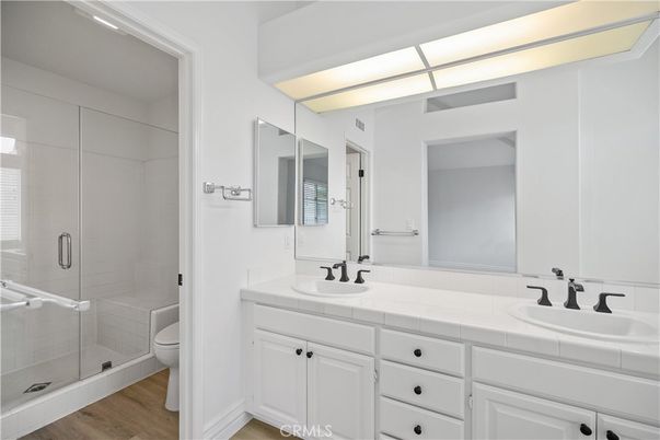 Bathroom, Dual Sink Vanities, Glass Shower, Interior, Tile Countertops, Wood Texture Flooring