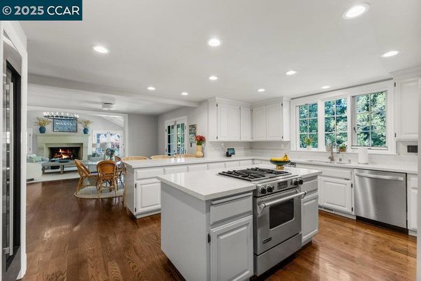 Dining room, Fireplace, Interior, Kitchen, Living room, Recessed Lighting, Stainless Steel Appliances, Wood Texture Flooring