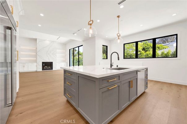 Fireplace, Interior, Kitchen, Marble Walls, Pendant Lights, Recessed Lighting, Stainless Steel Appliances, Wood Texture Flooring
