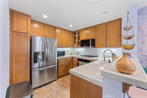 Interior, Kitchen, Recessed Lighting, Stainless Steel Appliances, Tile Countertops, Wood Texture Flooring