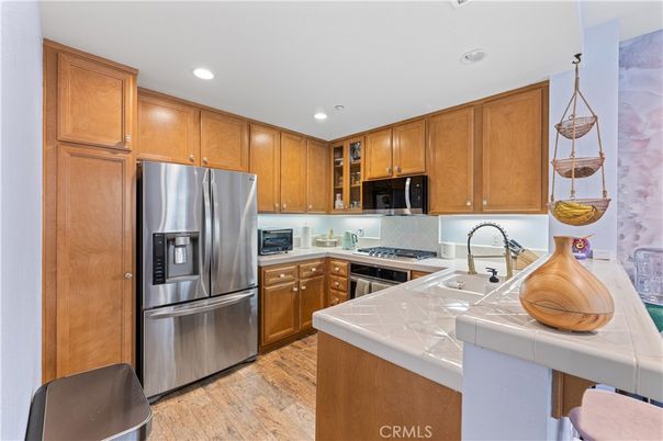 Interior, Kitchen, Recessed Lighting, Stainless Steel Appliances, Tile Countertops, Wood Texture Flooring